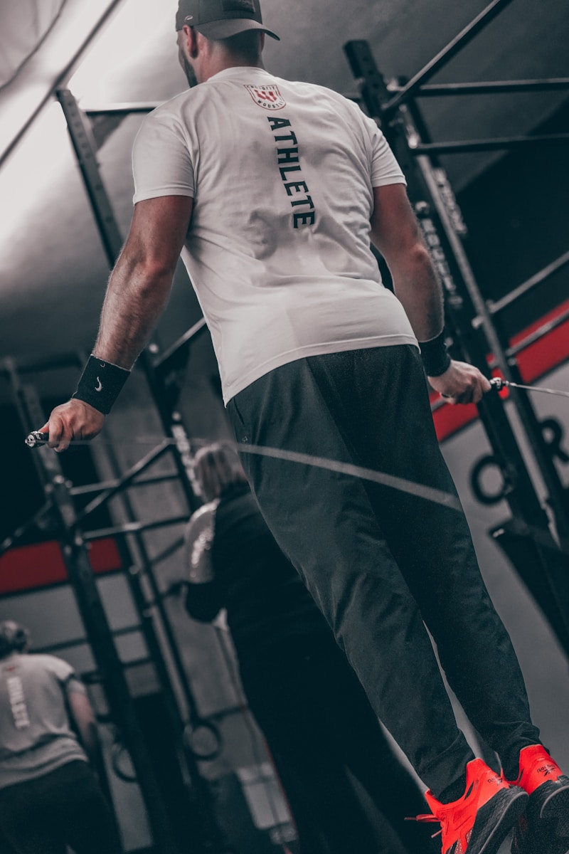 a man standing on a bar in a gym